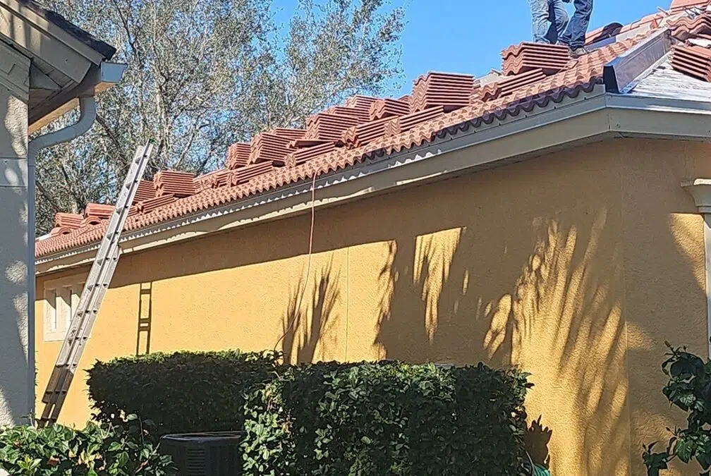 Worker installing roof tiles